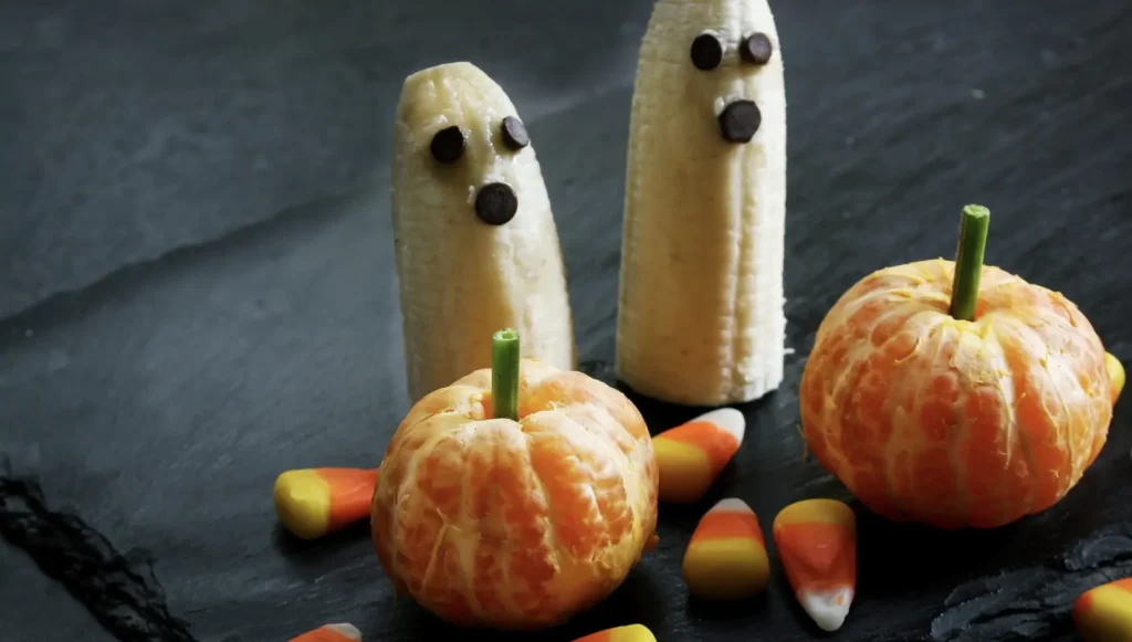 bananas with chocolate chip eyes and mandarin oranges that look like a pumpkin