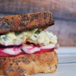 side view of roasted beets with egg salad sandwich