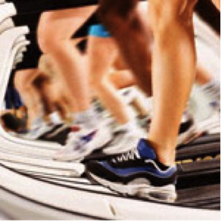 several pairs of running shoes on a treadmill trying to avoid workout weight gain