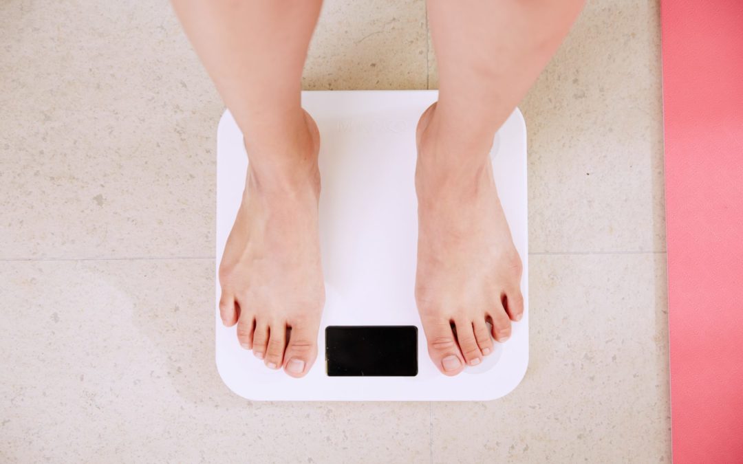 feet on a scale, menopause weight gain