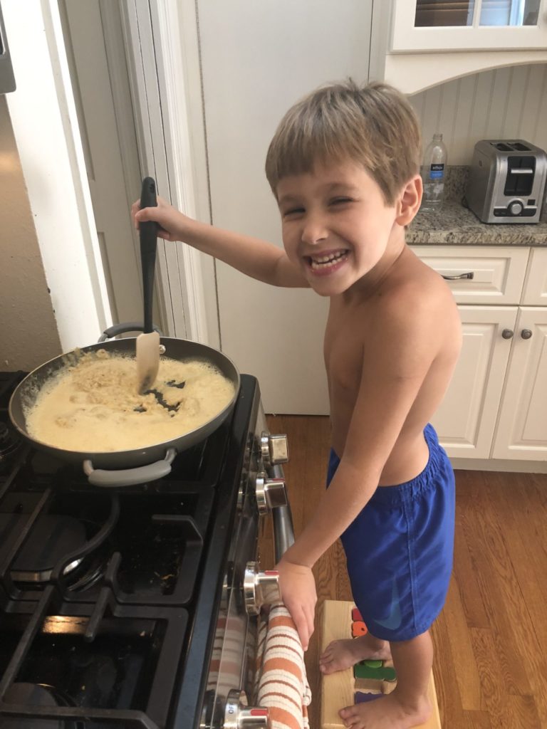 7 year old boy cooking spicy eggs showing how he can embrace making mistakes 
