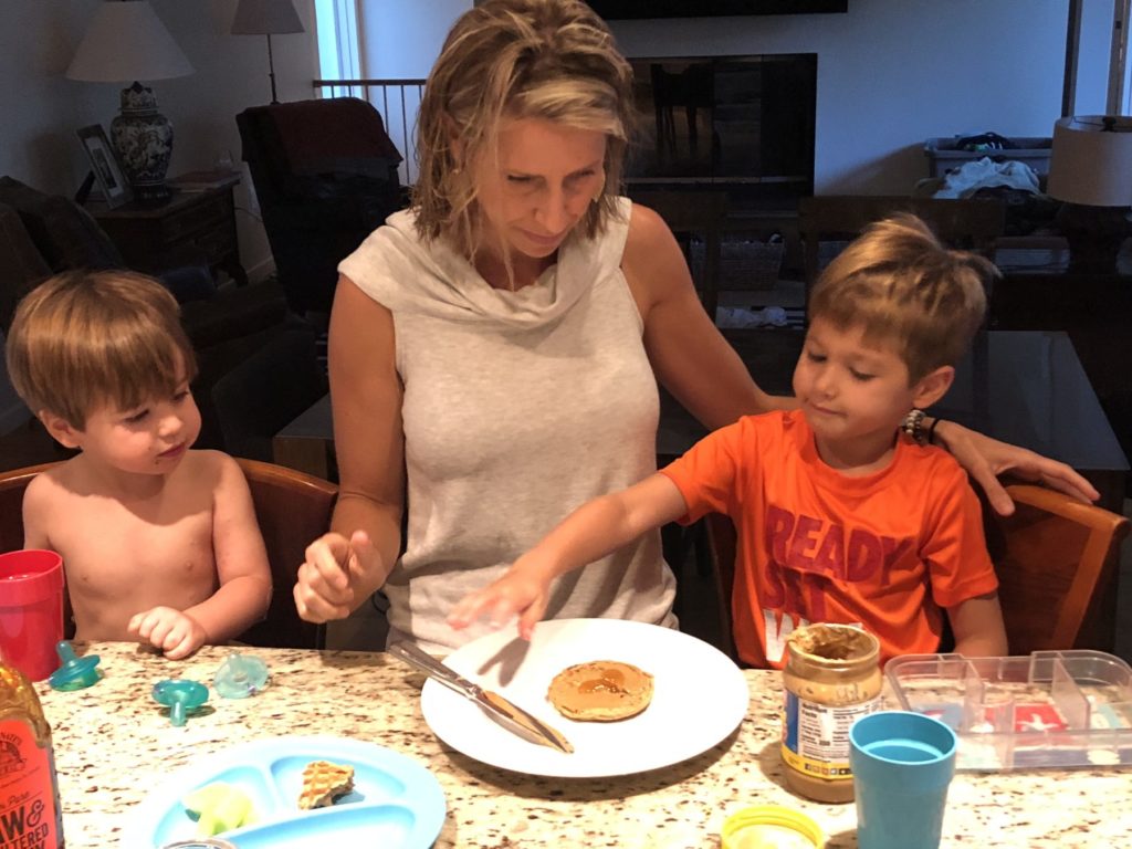 mom and her two sons making lunch