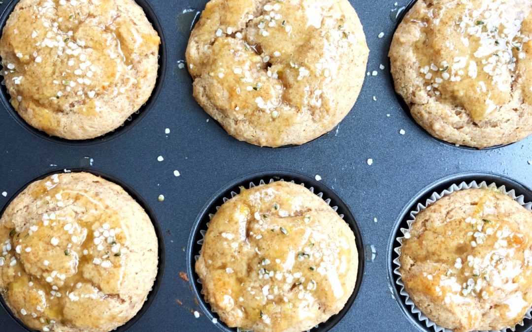 lemon muffins in the muffin tin, with hempseed sprinkles