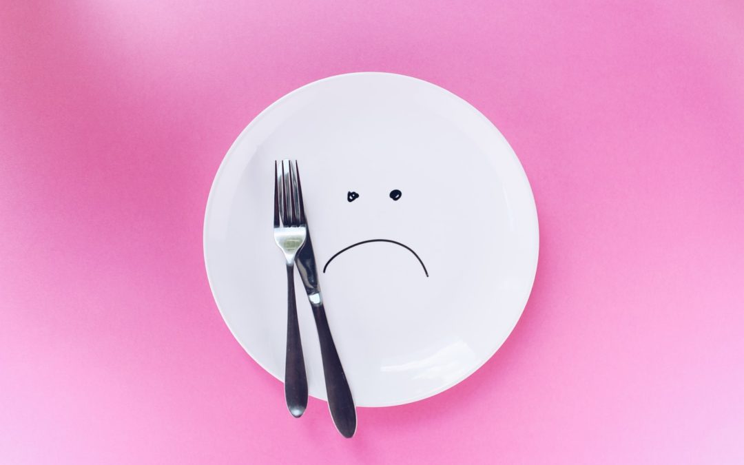 frown face with fork on pink background