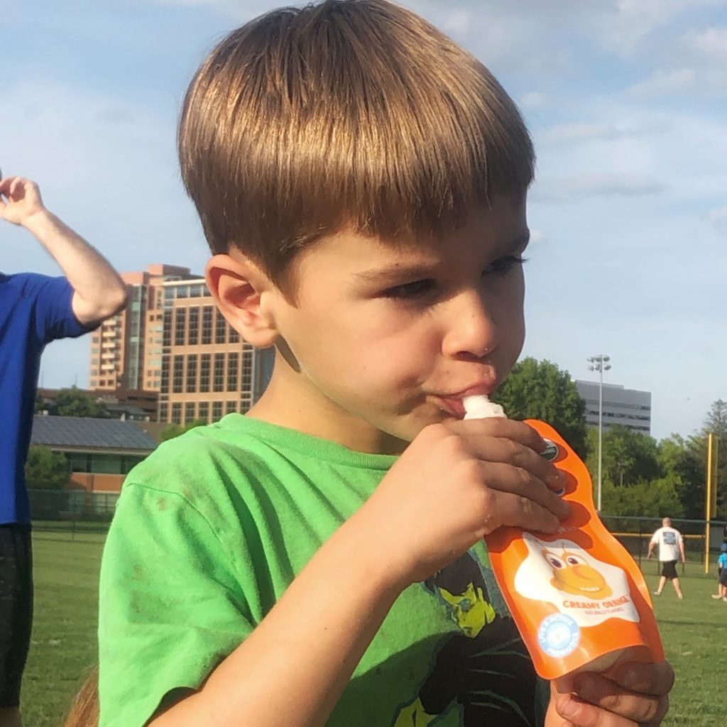 Boy drinking creamy orange probug drink