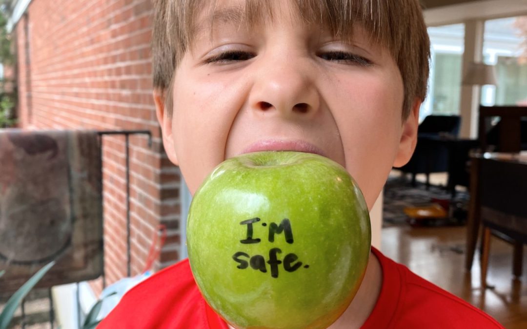 boy with an apple in his mouth that says "I'm Safe"