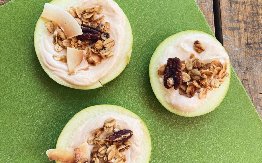 apple slices topped with yogurt dip and granola