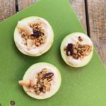 apple slices topped with yogurt dip and granola