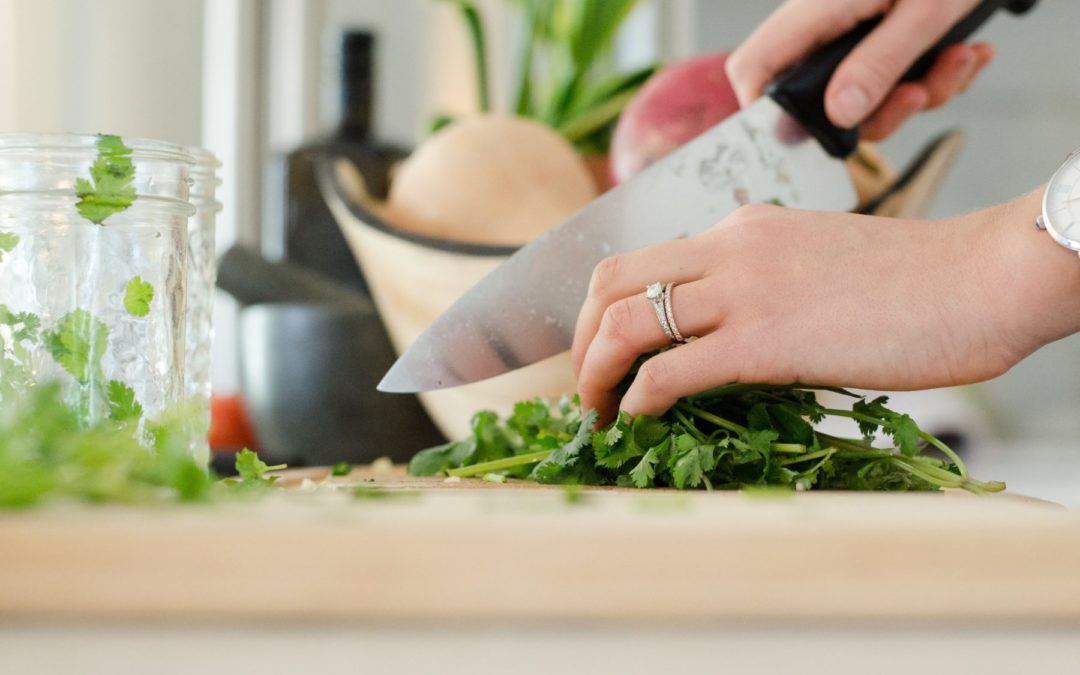 hand chopping parsley with a chef's knife