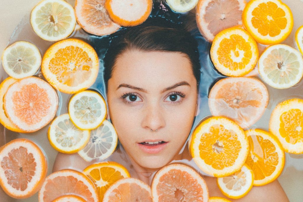 woman surrounded by lemon and orange slices