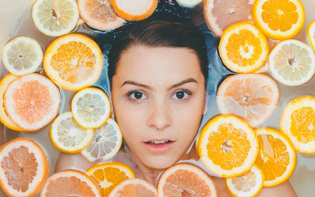 woman surrounded by lemon and orange slices