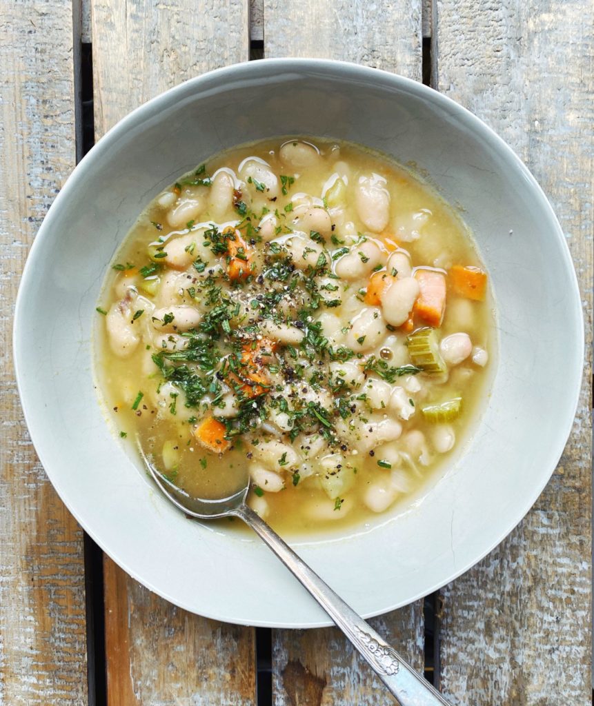 white bean soup in a grey bowl