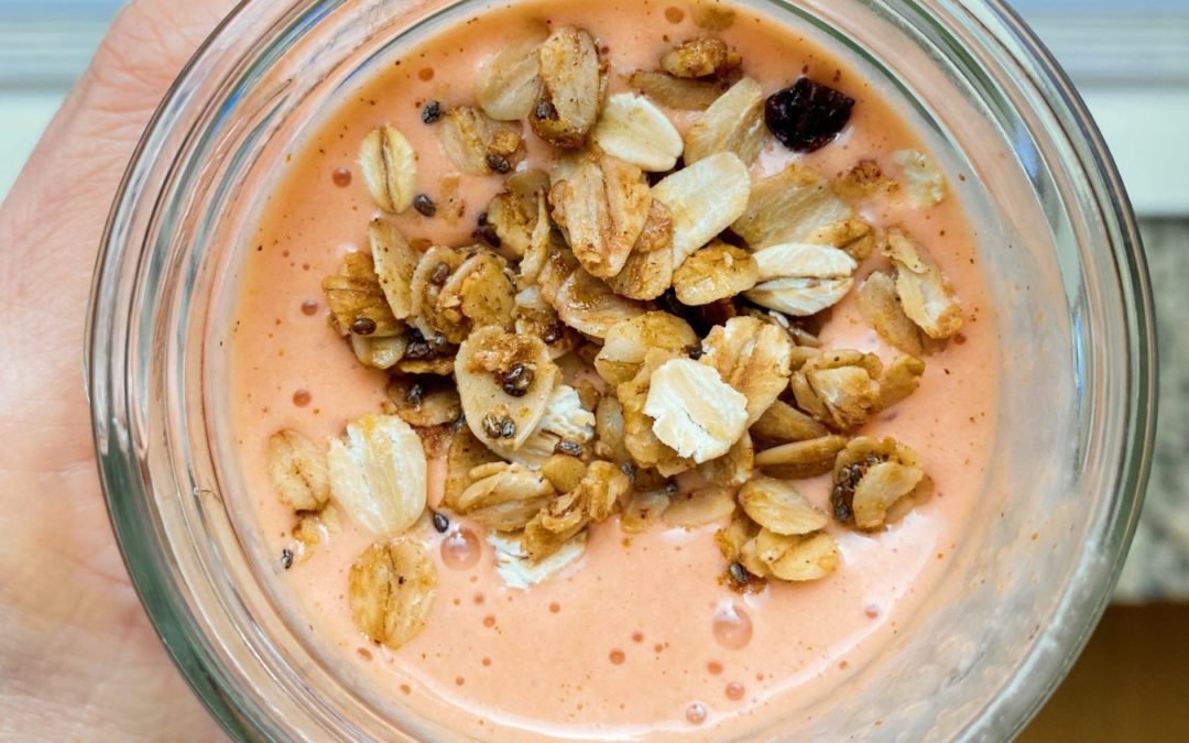 top of a carrot and beet smoothie with granola