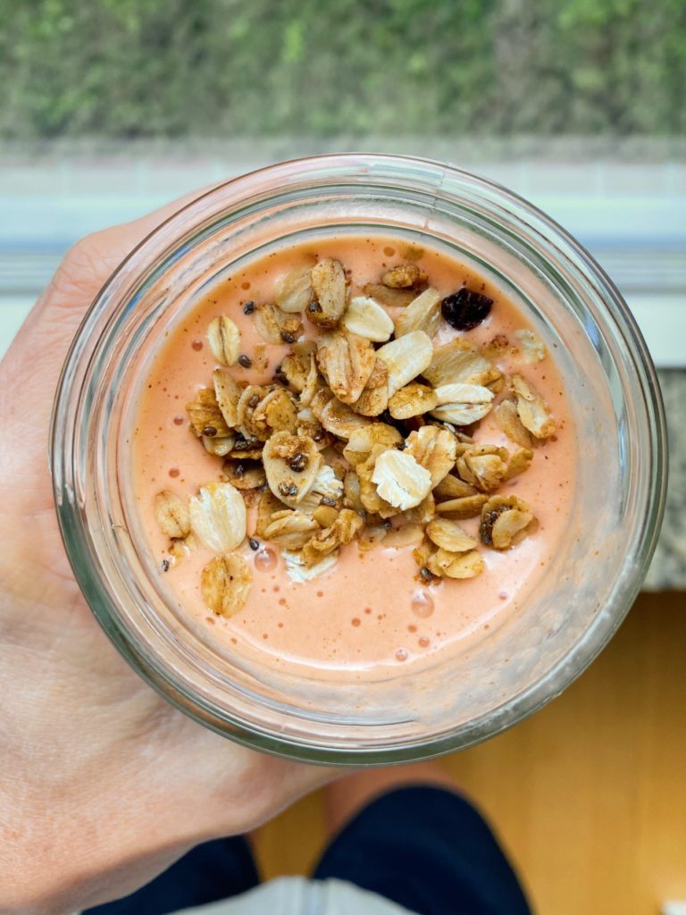 top of a carrot and beet smoothie with granola