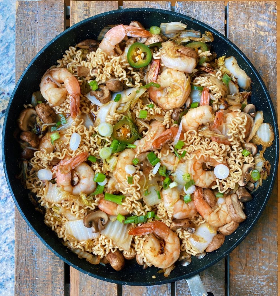 shrimp and ramen in a pan