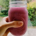 hand holding a pink smoothie