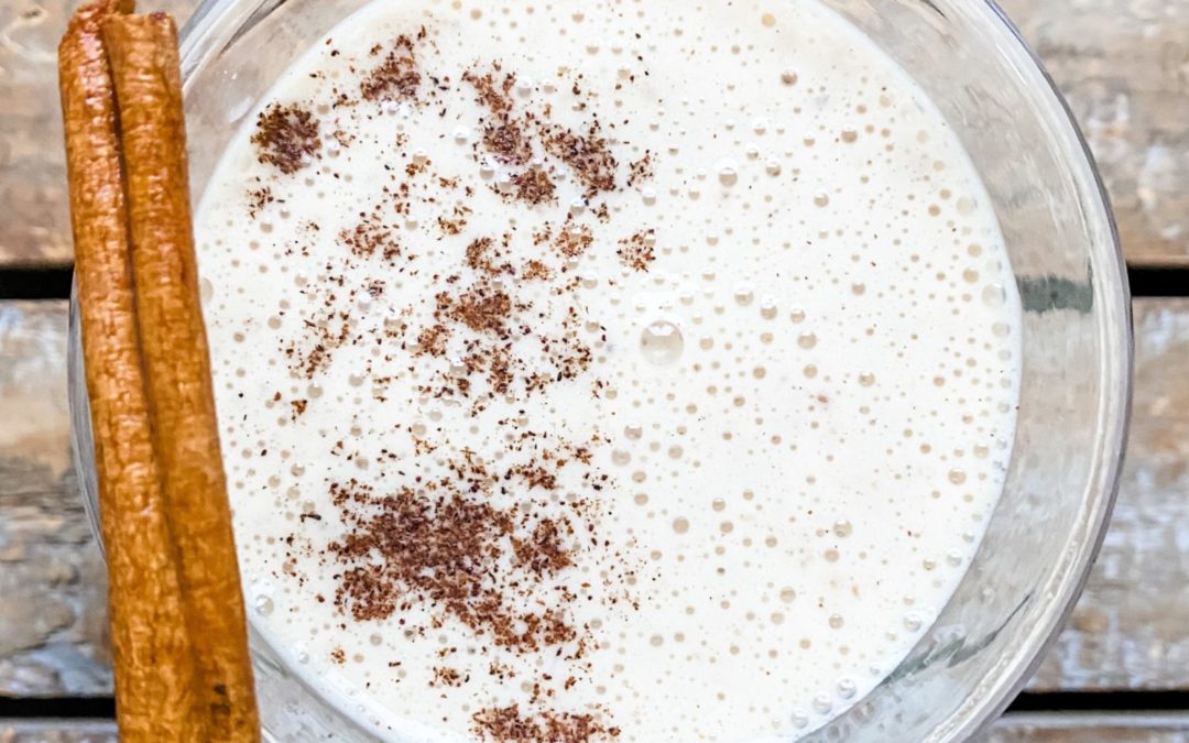 overhead view of eggnog smoothie with cinnamon stick