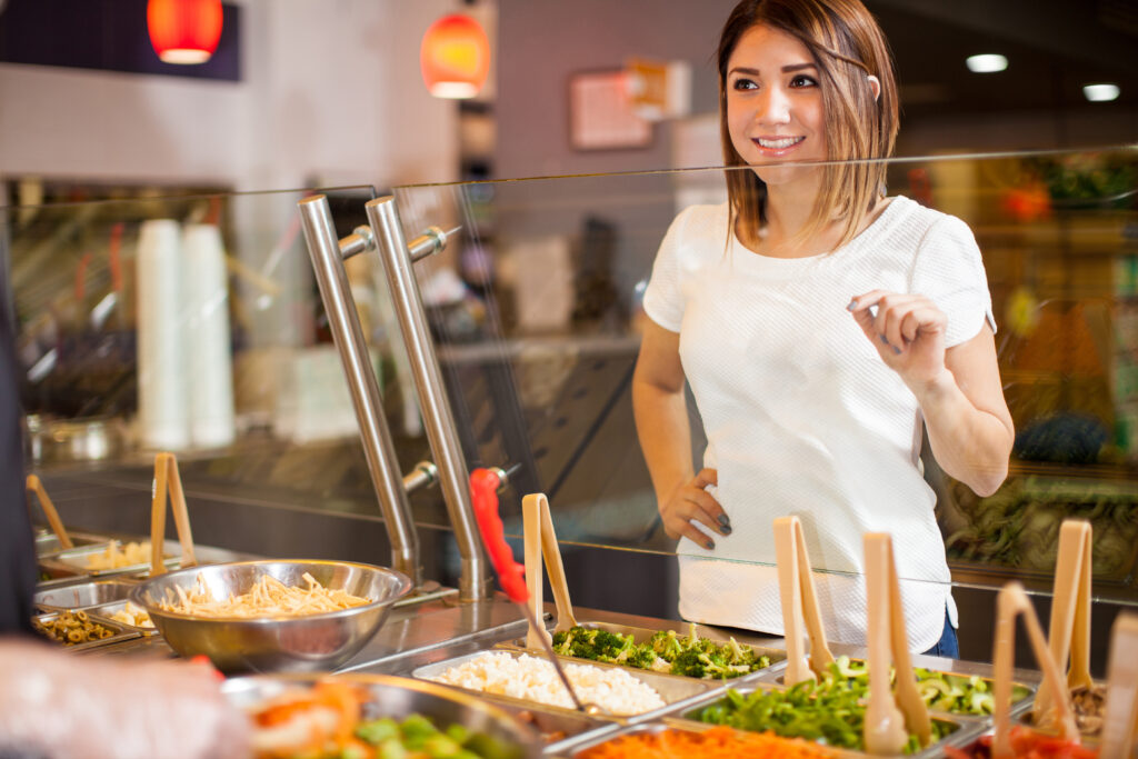 college students using healthy eating tips at a salad bar