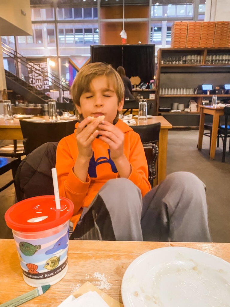 boy eating with his eyes closed 