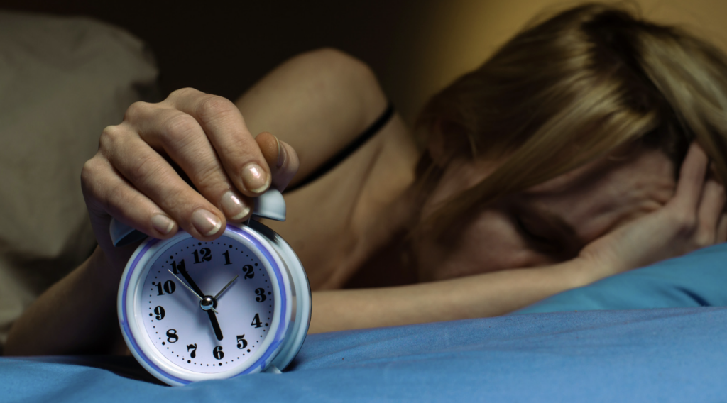 woman hitting the alarm and feels really tired