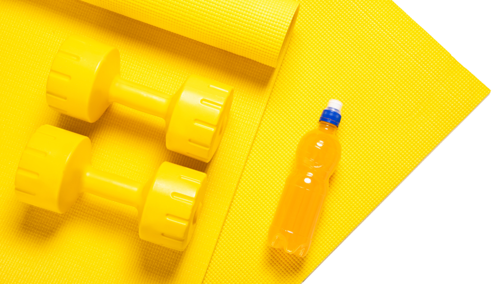 yellow yoga mat with yellow weights and a sports drink on the mat