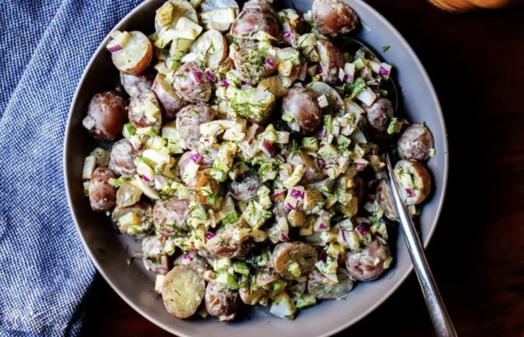 potato salad with a spoon in the dish