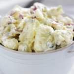 potato salad in a white serving dish