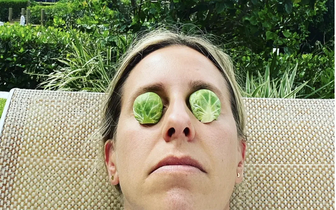 woman resting with brussel sprouts on her eyes for eye covers