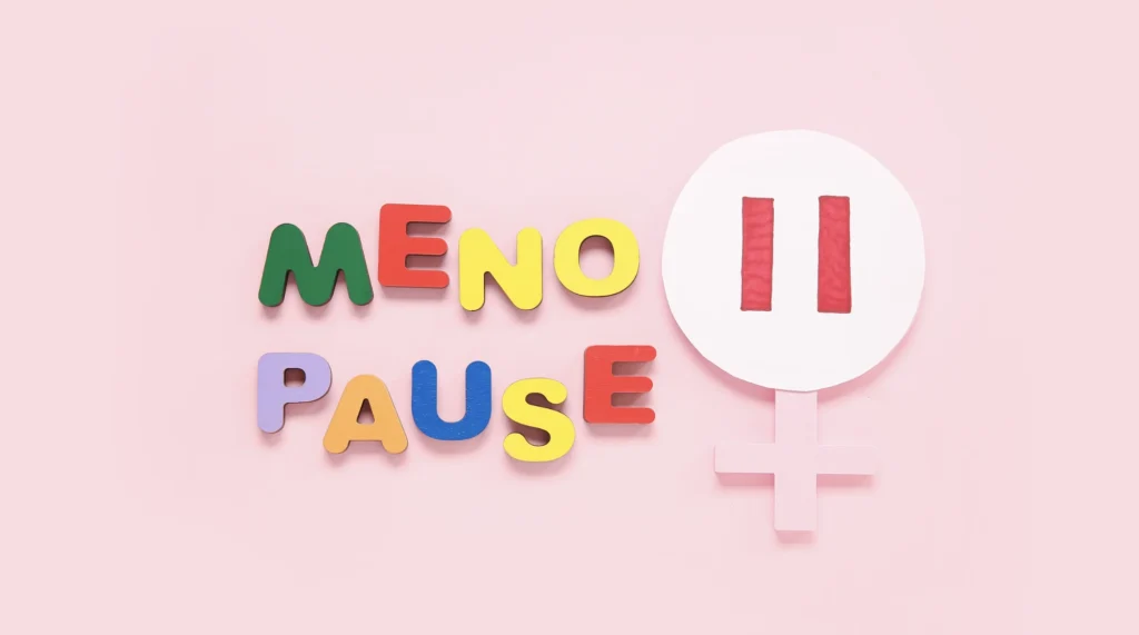 menopause written out in colorful letters with a pause button