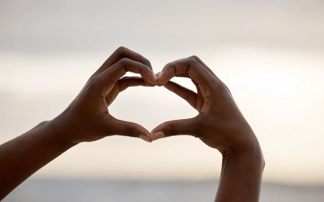 woman's hands making a heart shape