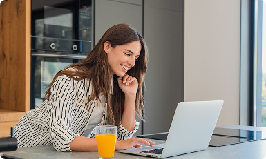 Client smiling at a laptop during a virtual nutrition appointment